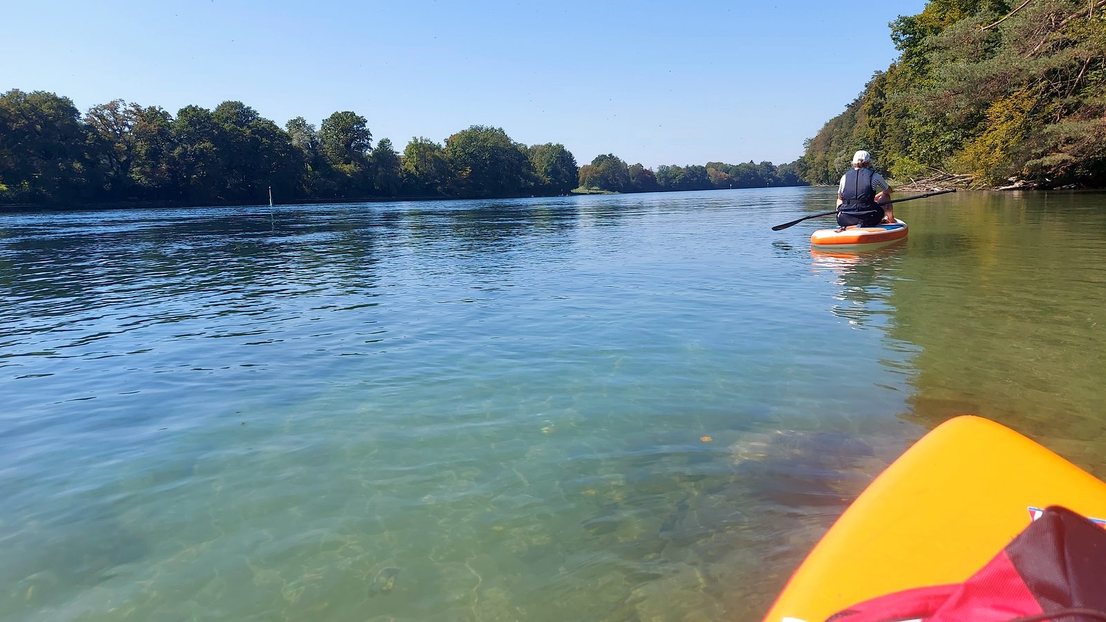 Weiter Blick über den türkisfarbenen Hochrhein mit einem Paddler in der Ferne